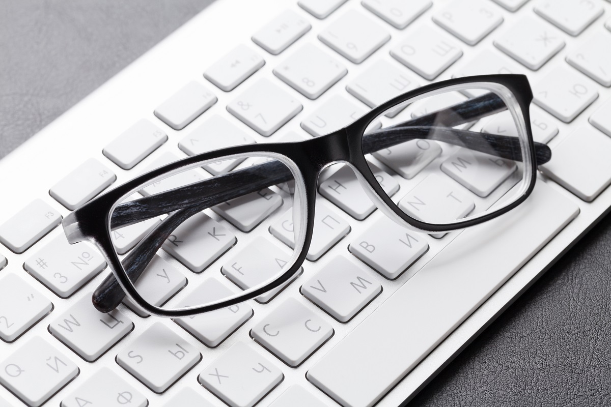 Office with eyeglasses over computer keyboard